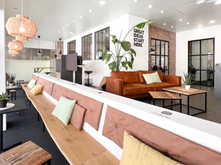 Modern workspace with sofas and sign.
