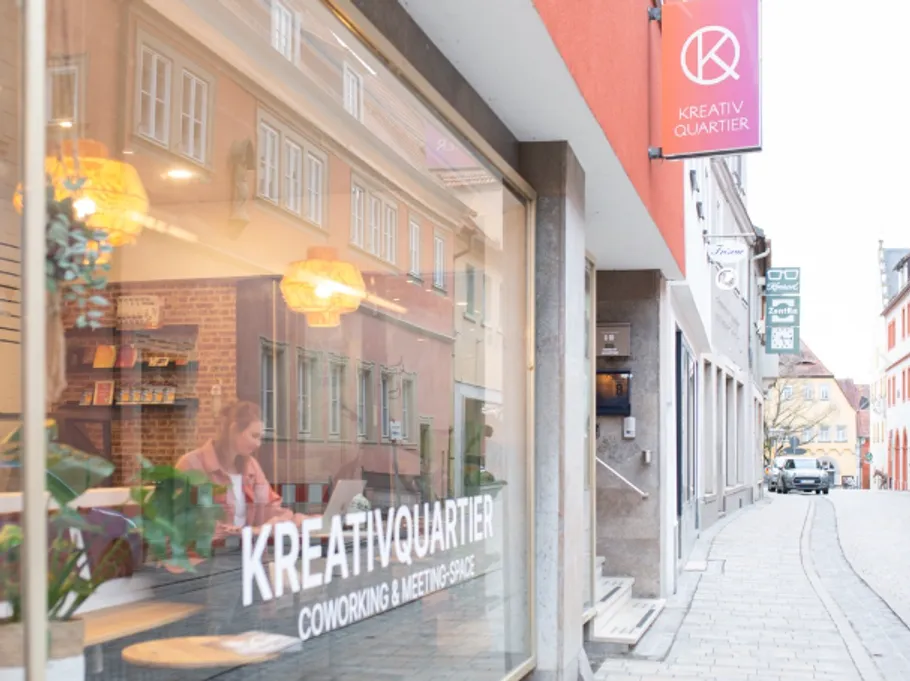 Coworking space with street view and reflections.