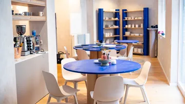 Blaue Tische und Stühle in modernem Café.
