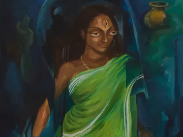 A woman wearing a green sari stands against a blue background.