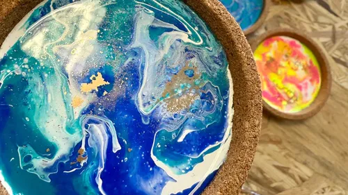 Colorful resin art piece with swirling patterns.