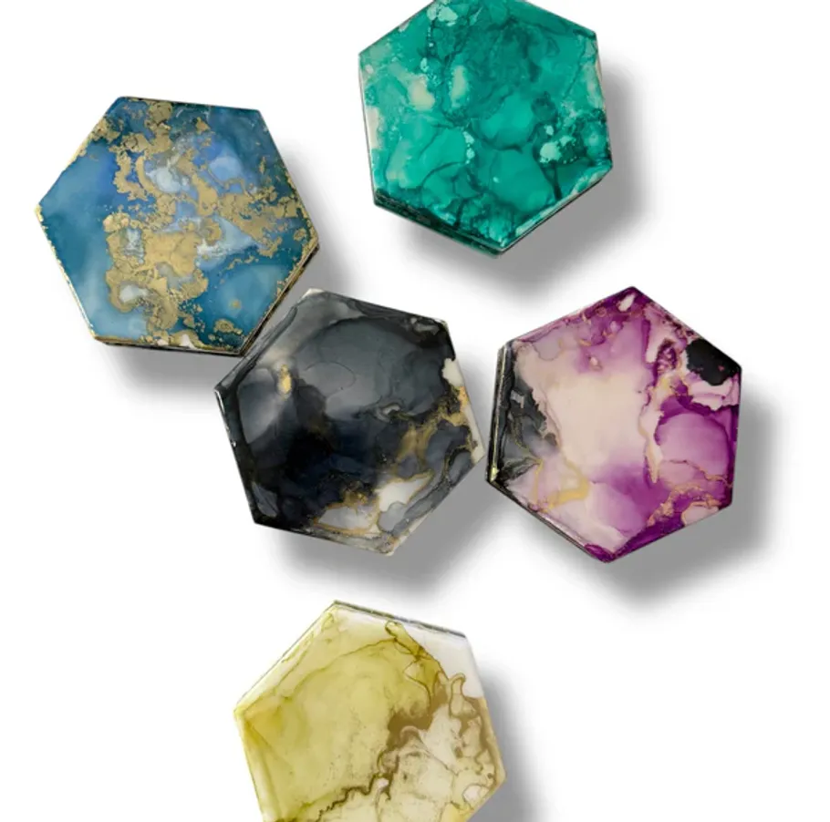 Colorful hexagonal stone coasters on white background.