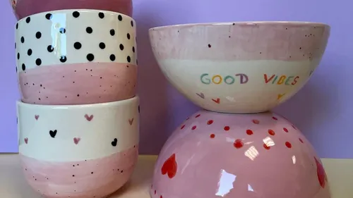 Stacked pink bowls with patterns and 'Good Vibes' text.
