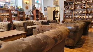 Leather sofas in a whiskey shop setting.