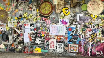 Colorful graffiti and posters on a wall.