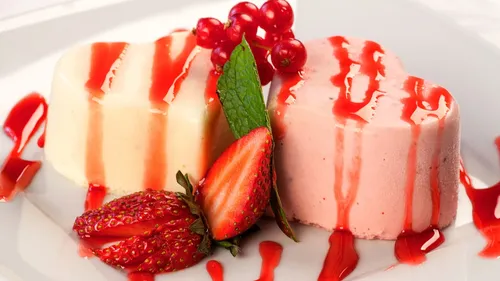 Two heart-shaped desserts with berry garnish.