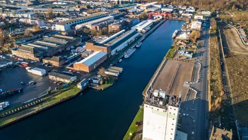 Industrial area along a river with warehouses.