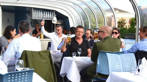 People drinking and socializing on a boat.
