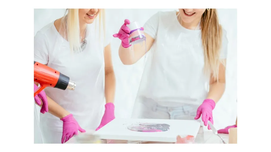 Women crafting with resin and heat gun.