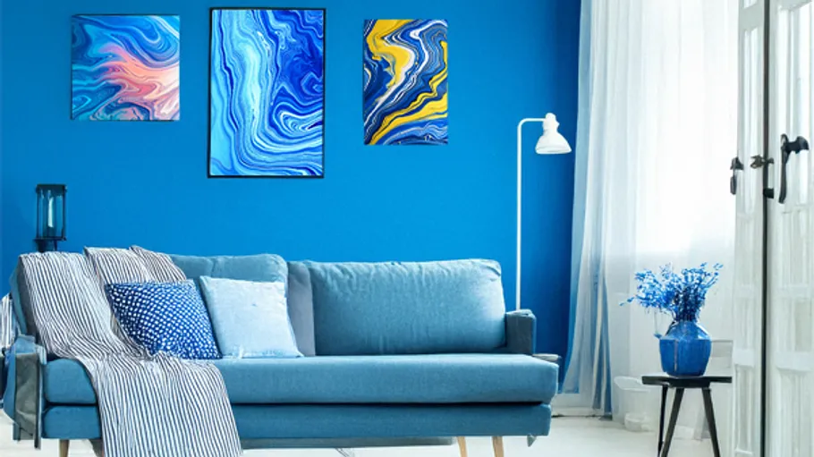 Blue-themed living room with abstract paintings.