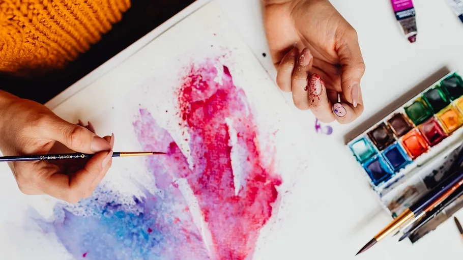 Person painting abstract art with watercolors.