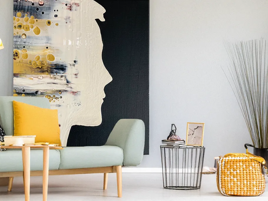 Modern living room with abstract face art.