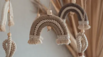 Macrame rainbows hanging in neutral decor setting.