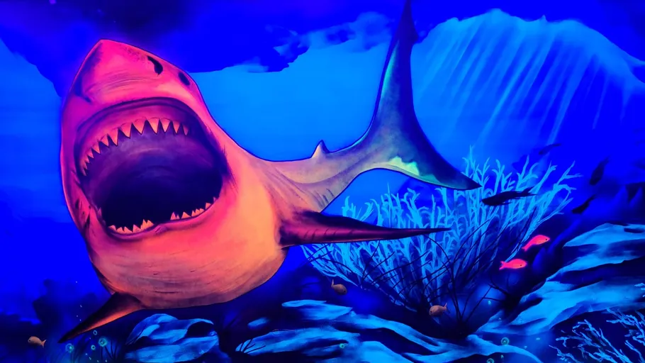Colorful shark aggressively swims in deep ocean.