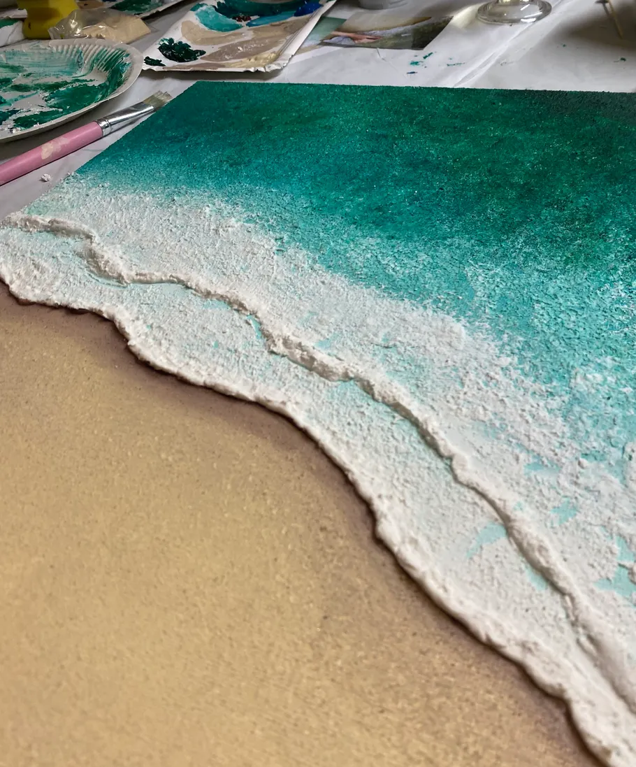 Textured beach painting with sand and ocean.