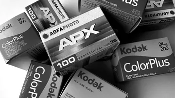 Film boxes arranged in monochrome pile.