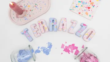 Colorful terrazzo letters surrounded by confetti.