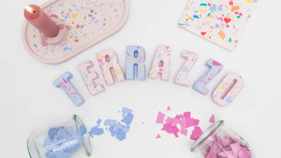 Colorful terrazzo letters surrounded by confetti.