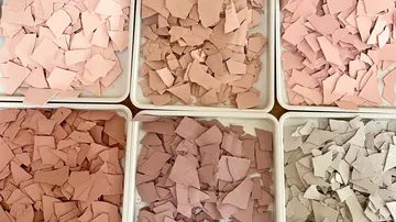 Six trays of varying colored clay shards.