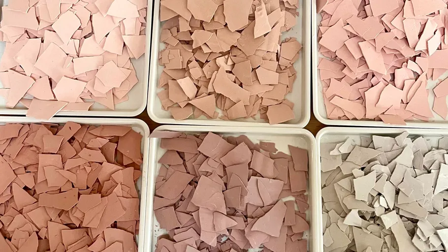 Six trays of varying colored clay shards.
