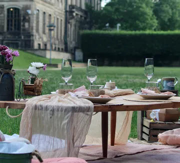 Outdoor table set with elegant dining items.