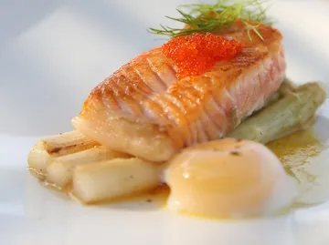 Grilled salmon with roe on white plate.