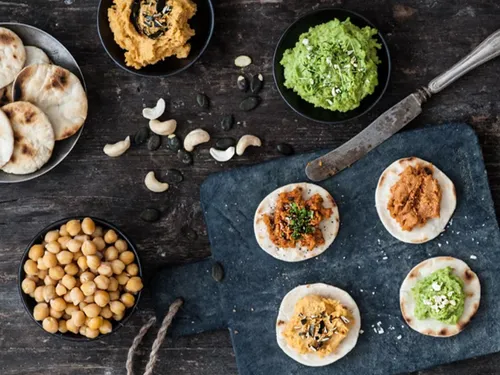 Flatbread with various spreads on a table.