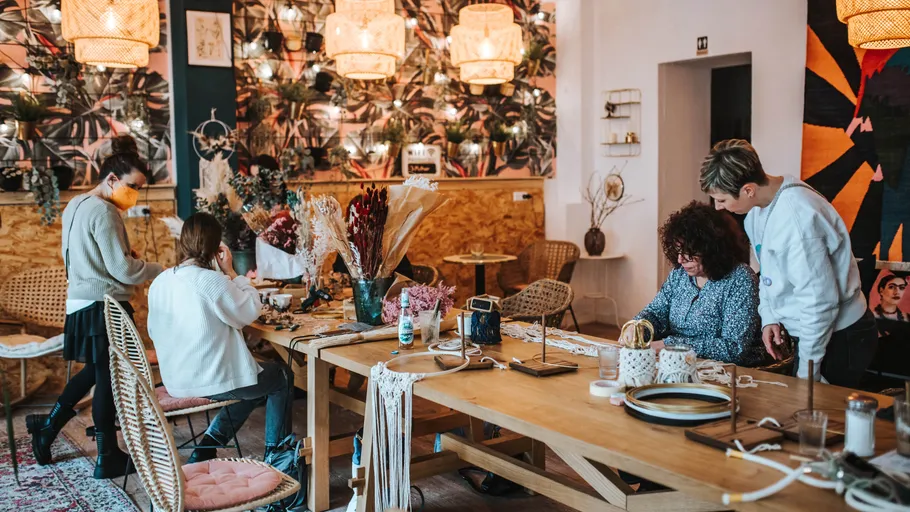 People crafting at a decorated workshop.