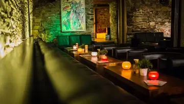 Cozy lounge with sofas and dim lighting.
