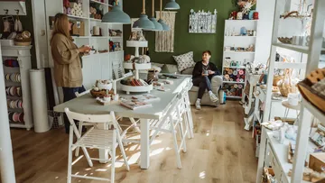 Two women in a cozy craft store.