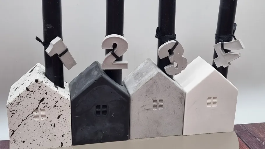Four house-shaped candle holders, black candles.