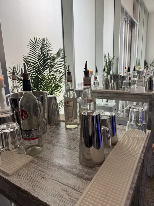 Bar setup with bottles and glasses indoors.