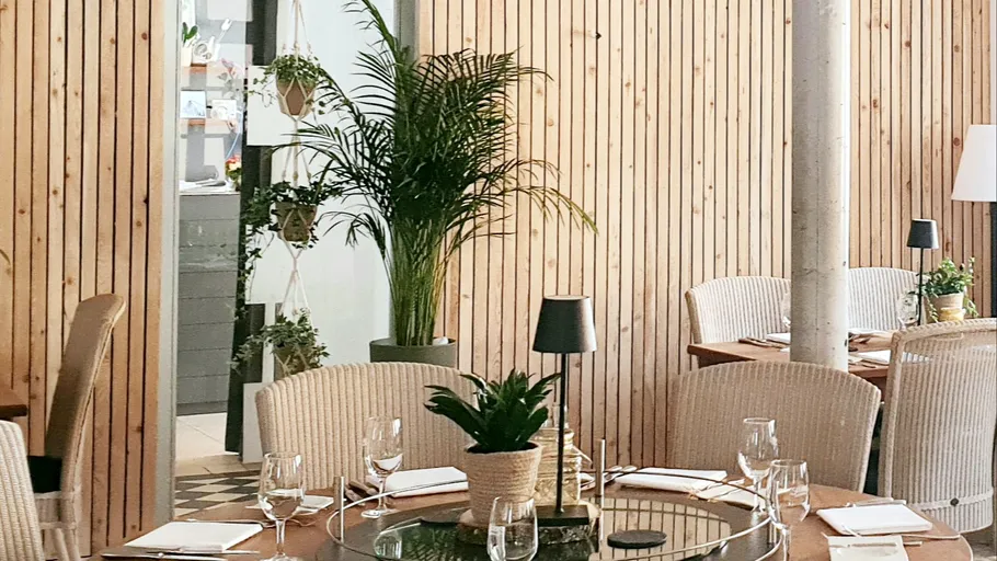 Restaurant with plants and wooden decor.