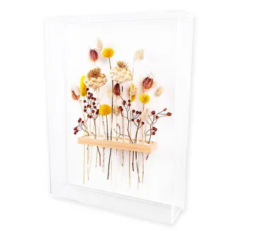 Dried flowers displayed in clear frame.