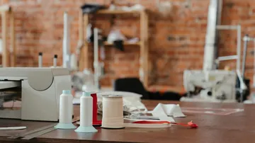 Sewing supplies on table in workshop.
