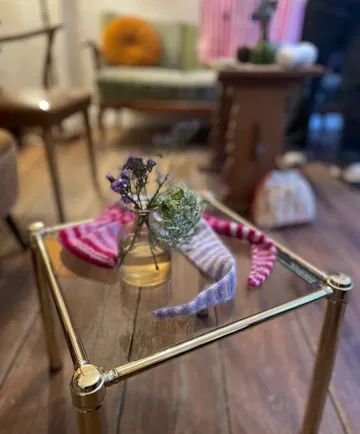 Glass table with vase and decor in living room.