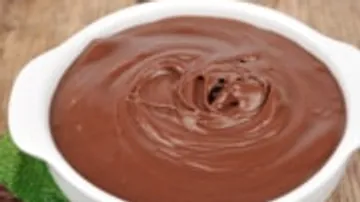 Chocolate pudding in a white bowl.