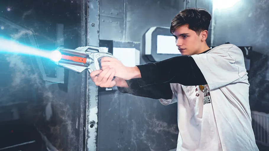 Person aiming toy gun in futuristic setting.