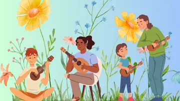 Four people playing ukuleles among flowers.