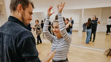 People dancing in a mirrored studio.