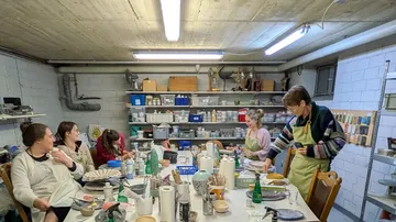 People crafting pottery in a workshop.