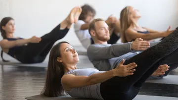 People doing yoga in a fitness class.