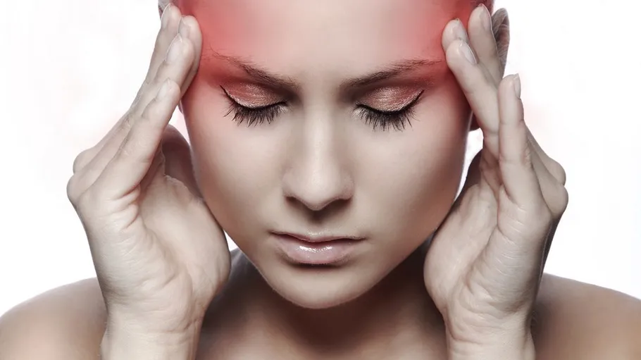 Person pressing temples, indicating headache pain.