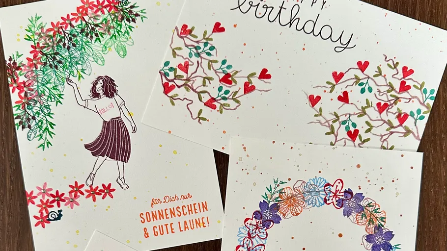 Colorful handwritten cards with floral designs.