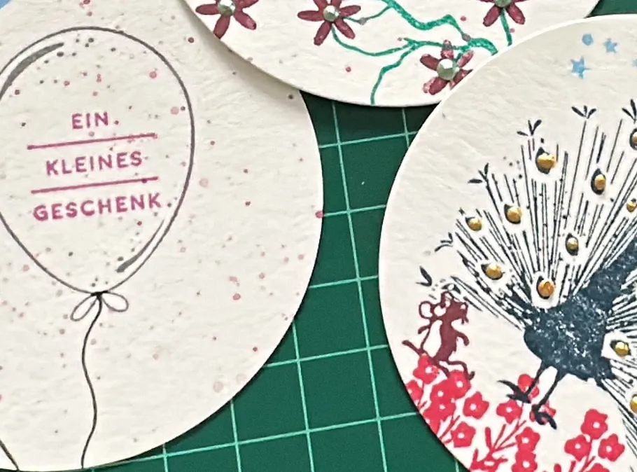 Decorative cards on a cutting mat.