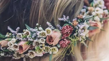 Floral crown on blonde hair outdoors.