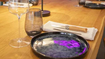 Table setting with glass, plate, and cutlery.