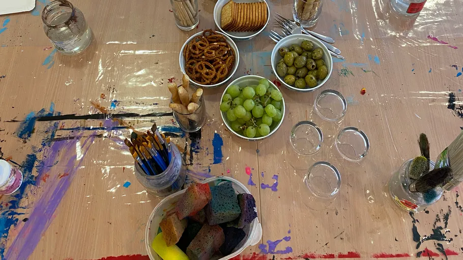 Art supplies and snacks on a painted table.