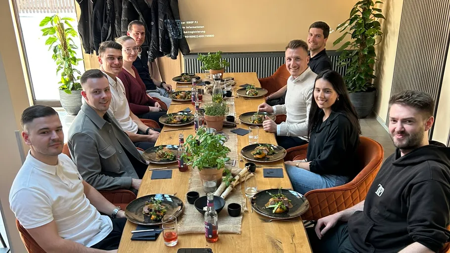 Group of people dining at a table indoors.