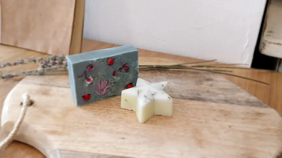 Decorative soaps on wooden tray with lavender.